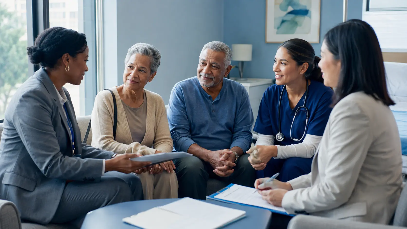 Health unit coordinator supporting a hospital transition conversation with an older adult patient, family caregiver, nurse, and receiving care coordinator.