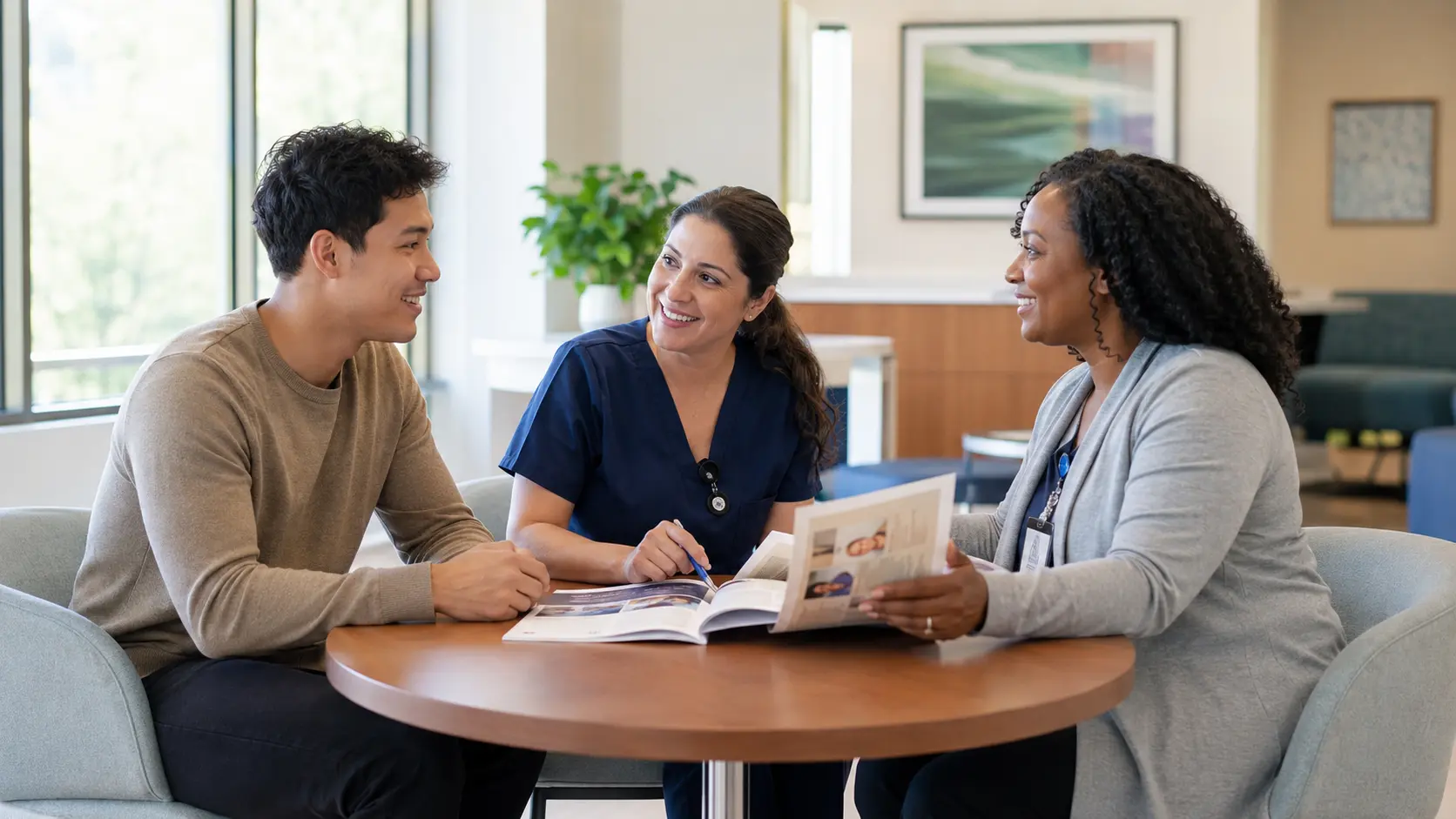 A young adult potential marrow donor meeting with a nurse navigator and registry coordinator around a table in a bright outpatient clinic.