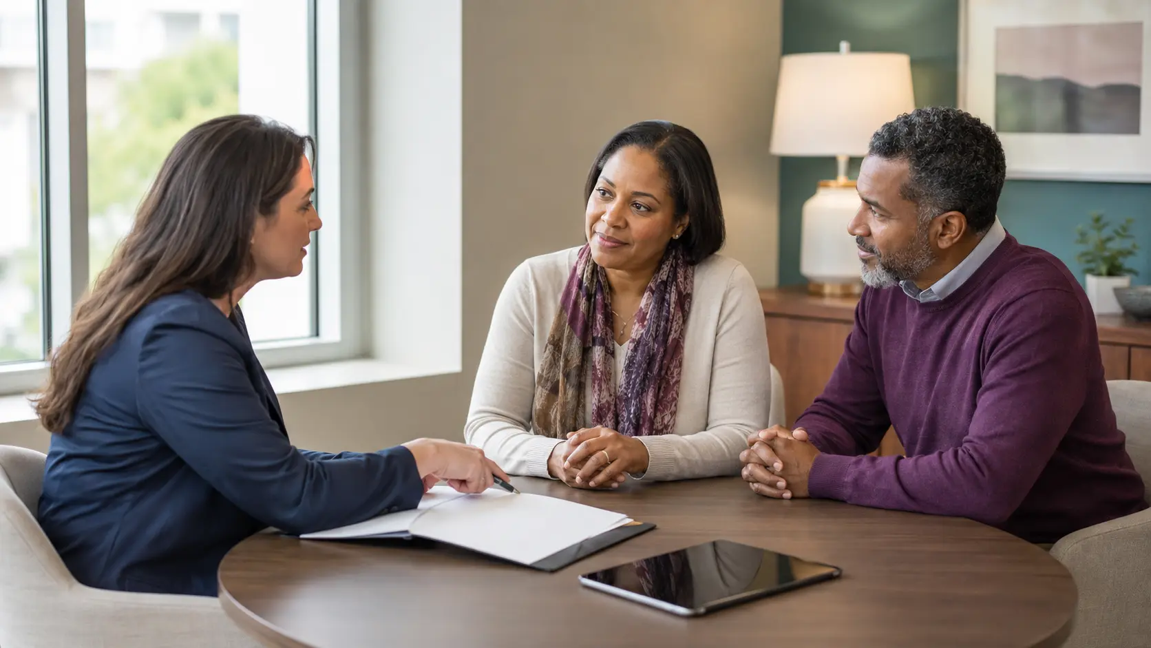A fictional adult patient and partner meeting with a clinical trial navigator in a private consultation room
