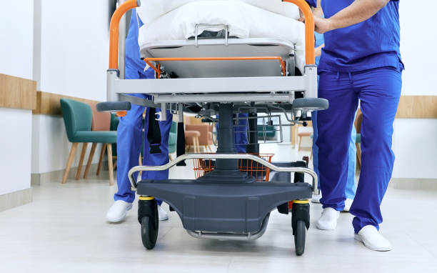 Efficiency in motion: Healthcare staff swiftly navigating an emergency department with a patient stretcher.