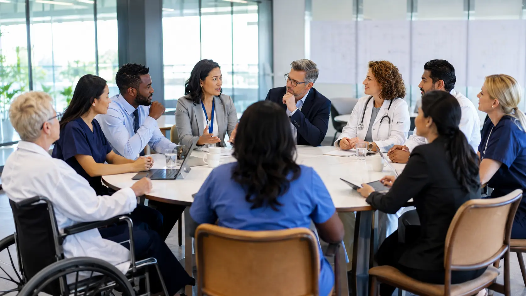 Healthcare executives and clinicians completing an interprofessional safety learning review.